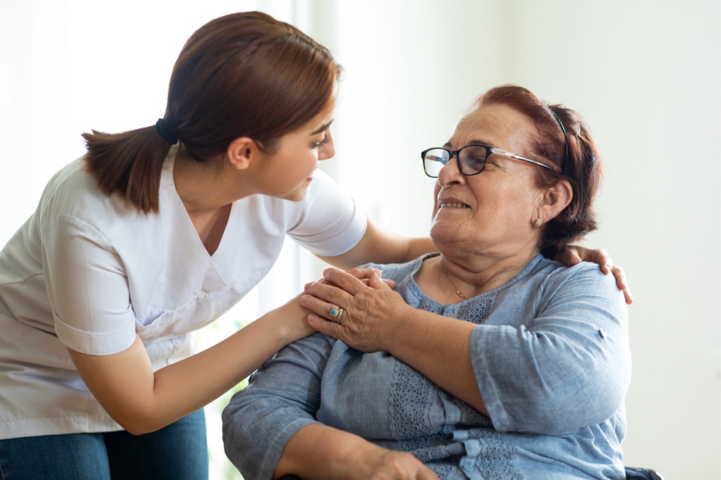 caring-nurse-talks-with-her-elderly-patient-picture-id1317942375